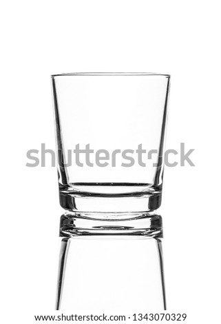 A single empty old fashioned glass isolated on a white background with reflection. High contrast black and white, black line lighting. 商業照片 © 
