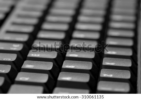 Computer keyboard. Close up of mostly blurred bands of keys.