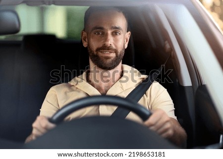 Similar – Image, Stock Photo Man sits in car and looks seriously out the window