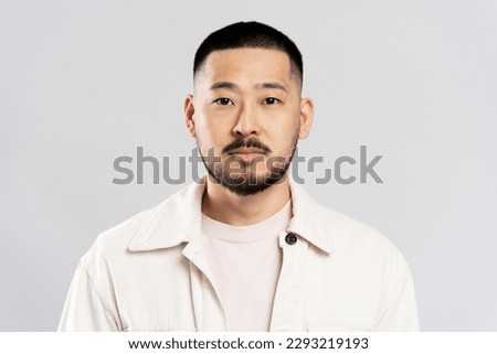 Image, Stock Photo Serious Asian man in face mask standing in gray corridor