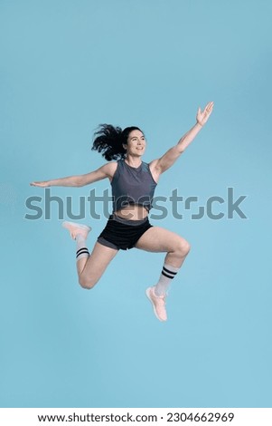 Similar – Image, Stock Photo Strong sportswoman jumping over sandy hill