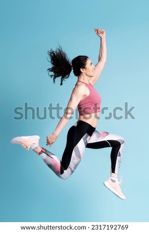 Similar – Image, Stock Photo Strong sportswoman jumping over sandy hill