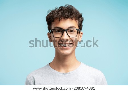 Similar – Image, Stock Photo Boy wearing glasses and looking at a display of a mobile under the supervision of an adult