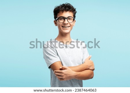 Similar – Image, Stock Photo Boy wearing glasses and looking at a display of a mobile under the supervision of an adult