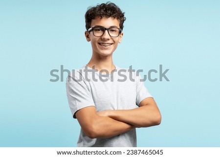 Similar – Image, Stock Photo Boy wearing glasses and looking at a display of a mobile under the supervision of an adult