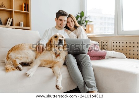 Similar – Image, Stock Photo Couple looking at laptop in kitchen.