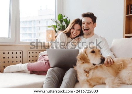 Image, Stock Photo Couple looking at laptop in kitchen.