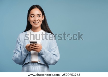 Similar – Image, Stock Photo Happy Asian woman browsing smartphone near car