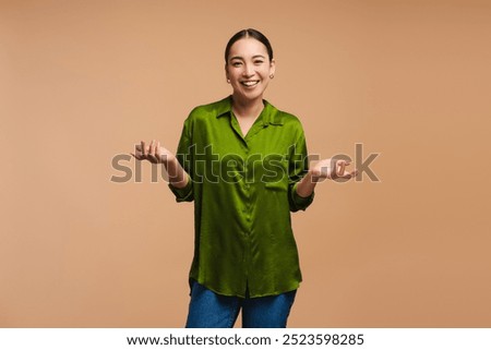 Similar – Image, Stock Photo Young woman wearing green oversize sweater enjoying a windy day in a colorful city