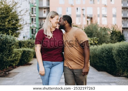 Similar – Image, Stock Photo Positive multiethnic couple kissing on street