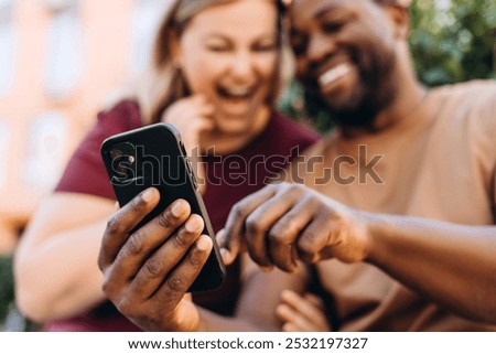 Similar – Image, Stock Photo Romantic multiethnic couple holding hands and strolling along city street