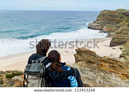 Romantic couple looking at beautiful view of Cape of Good Hope and ocean. Honeymoon vacation in South Africa