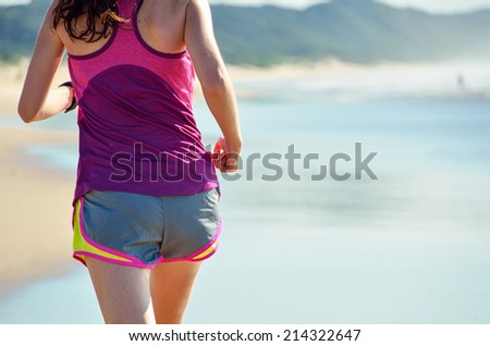 Woman running on beach, beautiful girl runner jogging outdoors, training for marathon, exercising and fitness concept