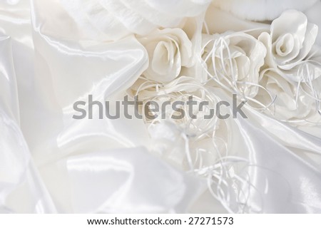 Smooth elegant white silk and silk flowers of bridal dress