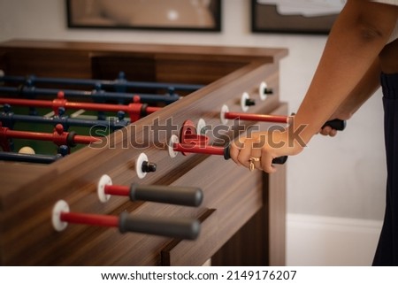 Hands of young black woman playing foosball in the game room
 Imagine de stoc © 
