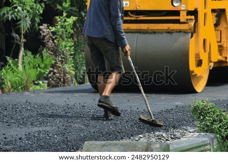 Similar – Foto Bild Arbeiter mit Asphaltfertigerwerkzeug beim Straßenbau.