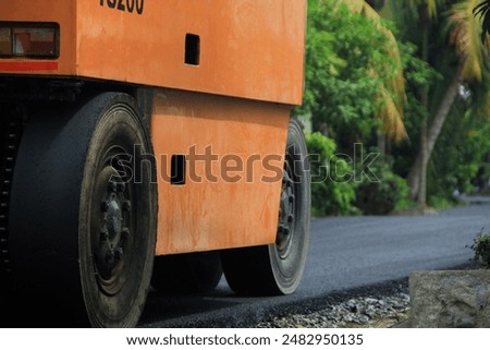 Similar – Foto Bild Arbeiter mit Asphaltfertigerwerkzeug beim Straßenbau.