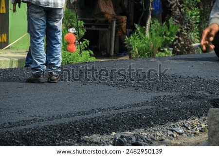 Similar – Foto Bild Arbeiter mit Asphaltfertigerwerkzeug beim Straßenbau.