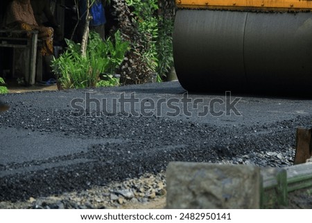 Similar – Foto Bild Arbeiter mit Asphaltfertigerwerkzeug beim Straßenbau.