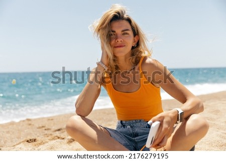 Similar – Image, Stock Photo Lady sitting on sandy coast near sea