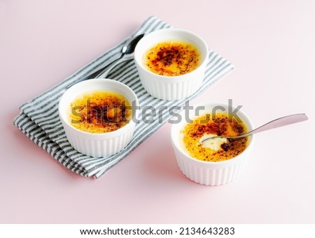Similar – Image, Stock Photo Creme brulee with caramel crust. Burning sugar on burnt cream