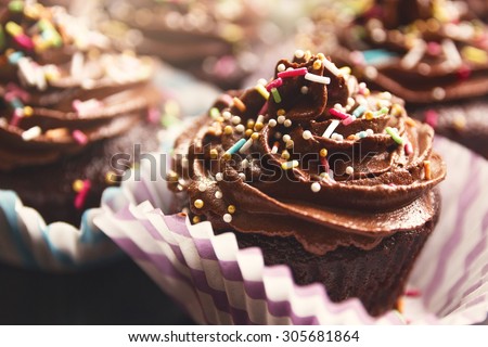 Delicious chocolate cupcakes with rich cream on the top