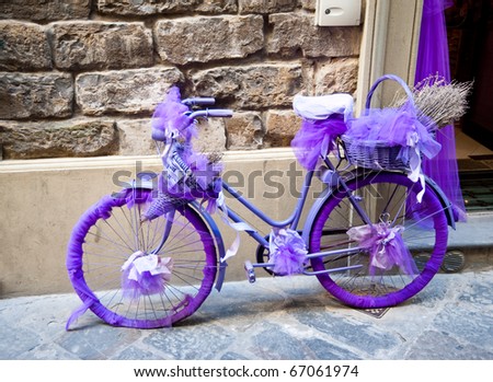 Bicycle wrapped in purple ribbon and fabric in Florence, Italy