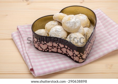 Small cookies in powdered sugar in a tin box in heart shape 4