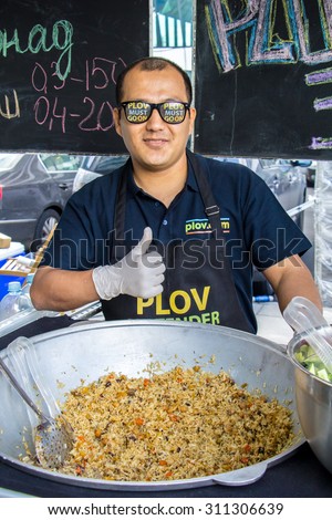 MOSCOW, RUSSIA - 29 AUGUST, 2015: Urban food market, traditional spicy food called pilaf, cook.