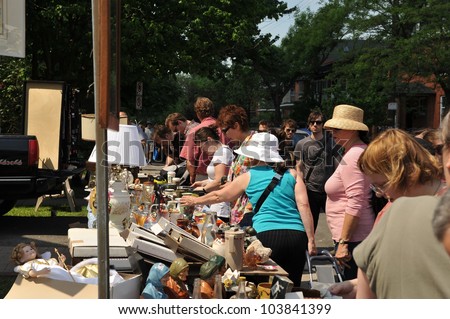 OTTAWA, CANADA - MAY 26: Thousands of people gather at the annual Glebe neighborhood garage sale which takes place for several blocks May 26, 2012 in the Glebe area of Ottawa, Ontario.