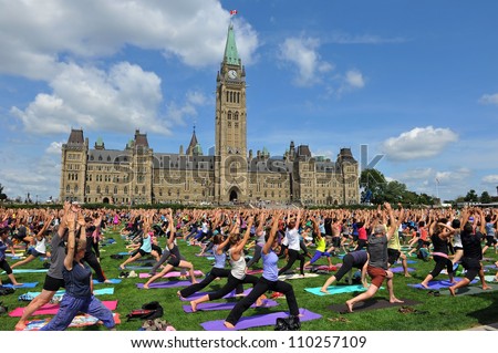 OTTAWA, CANADA – AUG 15:  For the past six years people have gathered on Parliament Hill at lunch on Wednesdays to do yoga.  A new record was set when 2400 participated August 15, 2012 Ottawa, Canada.