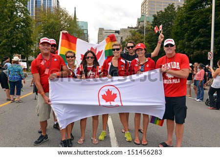 OTTAWA - AUG 25:  A group of people, including Canadian ex-Olympic athletes, holds the Canadian Olympic flag in support of Gay rights at the annual Gay Pride Parade Aug 25, 2013 in Ottawa, Canada.
