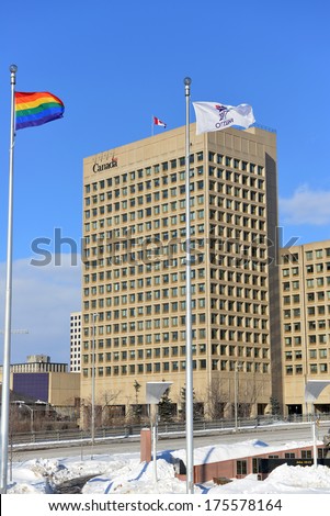 OTTAWA - FEB 8:  The Gay Pride flag is flown at Ottawa City Hall, with the Dept of National Defense HQ in the background,  to show support for Gay Rights in Sochi Feb 8, 2014 in Ottawa, Canada
