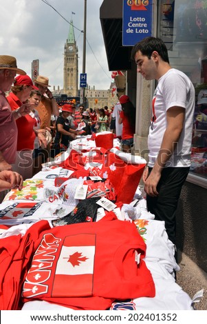 OTTAWA - JULY 1:  Vendor sells Canada related goods to the thousands of people who visit Parliament Hill for Canada Day celebrations in the national capital July 1, 2014 in Ottawa, Ontario.
