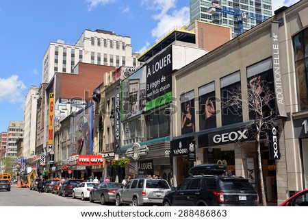 MONTREAL, CANADA - JUN 13, 2015:  The busy Saint Catherine Street, the main street in the city containing many retail stores, restaurants, bars and strip clubs.