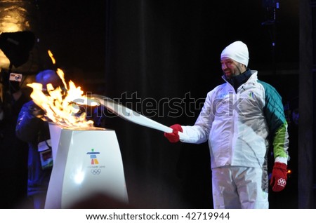OTTAWA, CANADA - DECEMBER 12: Joe Juneau lighting the torch at the Olympic Torch Relay ceremony in preparation for the 2010 Winter Olympics.  Ottawa, December 12, 2009.