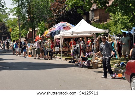 OTTAWA, CANADA -MAY 29:   Thousands of people gather at the annual Glebe neighborhood garage sale which takes place for several blocks in the Glebe area of Ottawa, Ontario May 29, 2010.