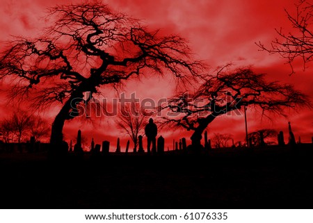 Scary pic of cemetery with hellfire sky and scary trees.  Perfect for Halloween or horror themes.