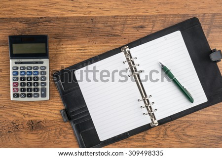 notebook and pen with calculator on the desk finance plan