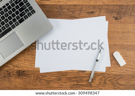 Laptop, paper pen and Eraser on work desk sketching planning