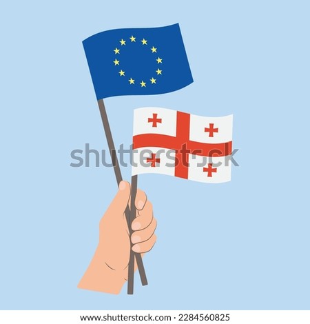 Flags of EU and Georgia, Hand Holding flags
