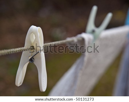 Clothes peg on clothes line in close up background blurred.