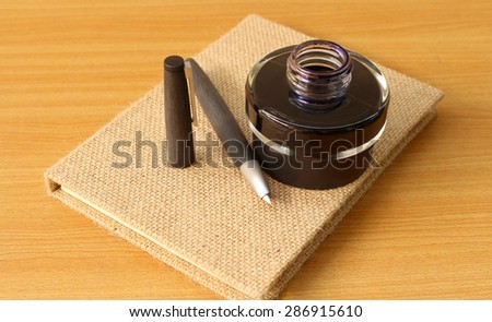 Book and fountain pen with ink bottle
