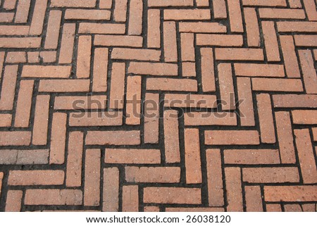 Ancient pavement made of red terracotta bricks on earth.