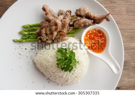 Parsley rice with BBQ pork and asparagus on plate