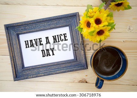 Cup of black coffee on the table and wishing a nice day note