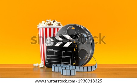 Film reel with popcorn and film slate on orange background. 3d illustration