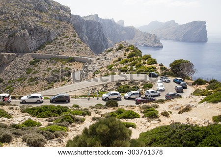 CAP DE FORMENTOR, MALLORCA - 29 JULY 2015. Lots of cars and queuing on mountain roads during the peak of the busy tourist season.  Signs of crowding on the busy tourist roads around Mallorca