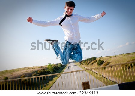 happy man jumping to the sky on the bridge