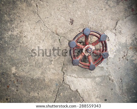 water supply valve on cement floor